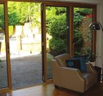 Bifold doors composite - Combining the natural beauty of timber on the inside with maintenance-free aluminium on the outside - IDSystems